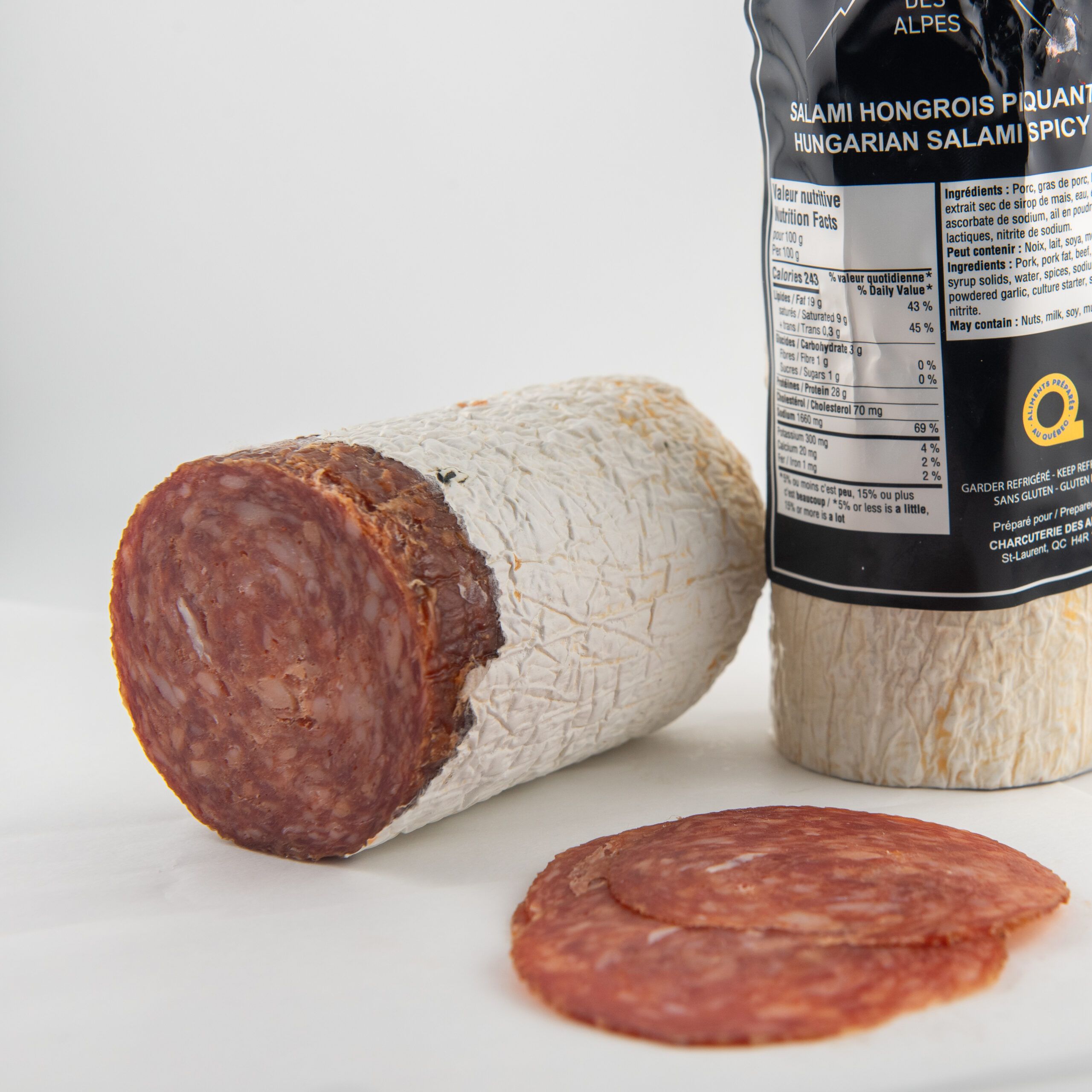 Slices of spicy Hungarian salami on wooden board