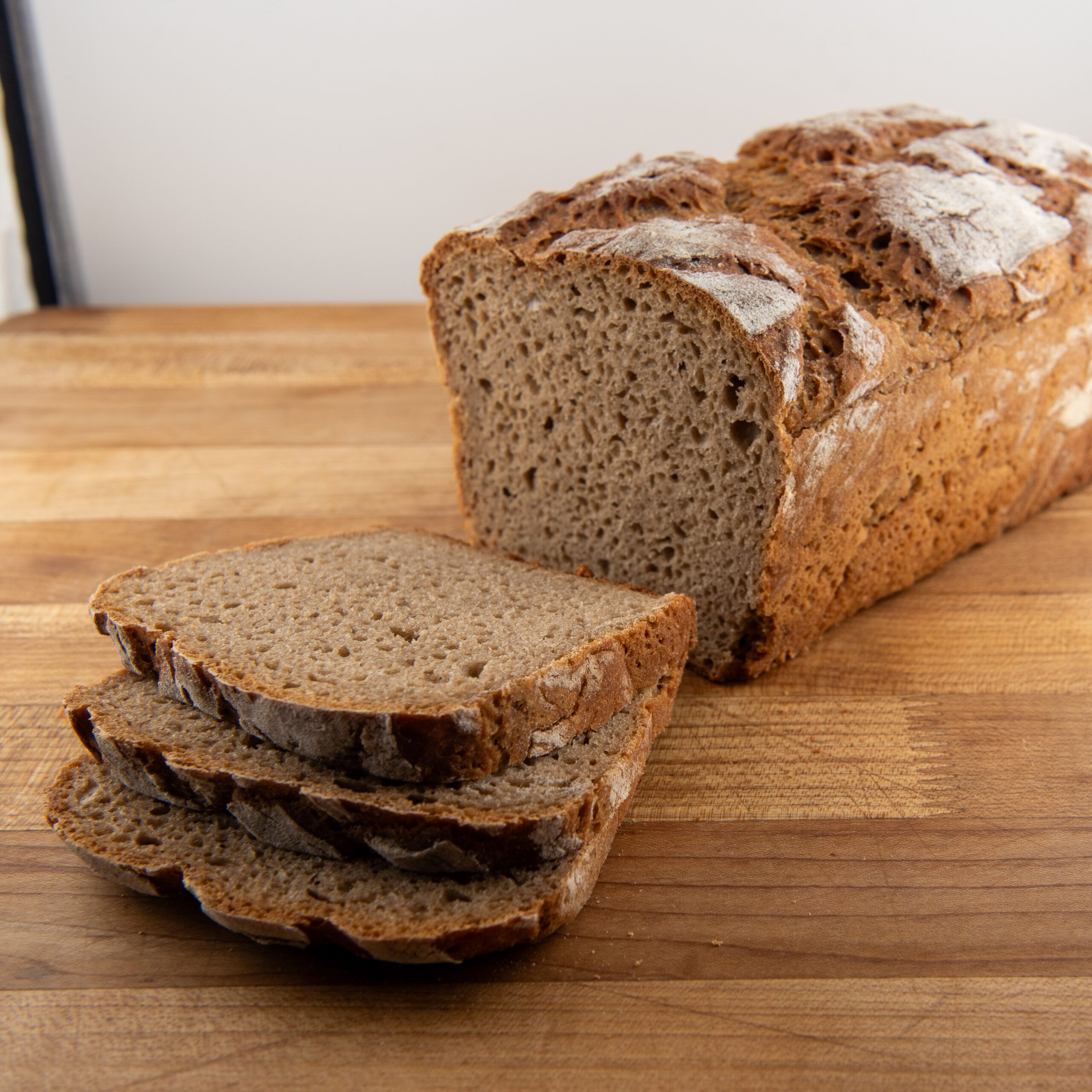 Gluten-free rye bread, sliced, on a wooden table