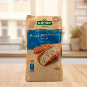 Bag of Kupiec Hulled Barley Groats on a wooden table, showcasing authentic Polish packaging.