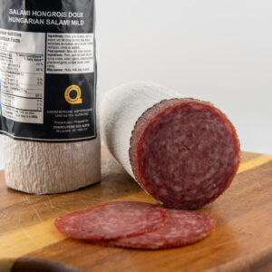 Mild Hungarian salami slices on wooden board
