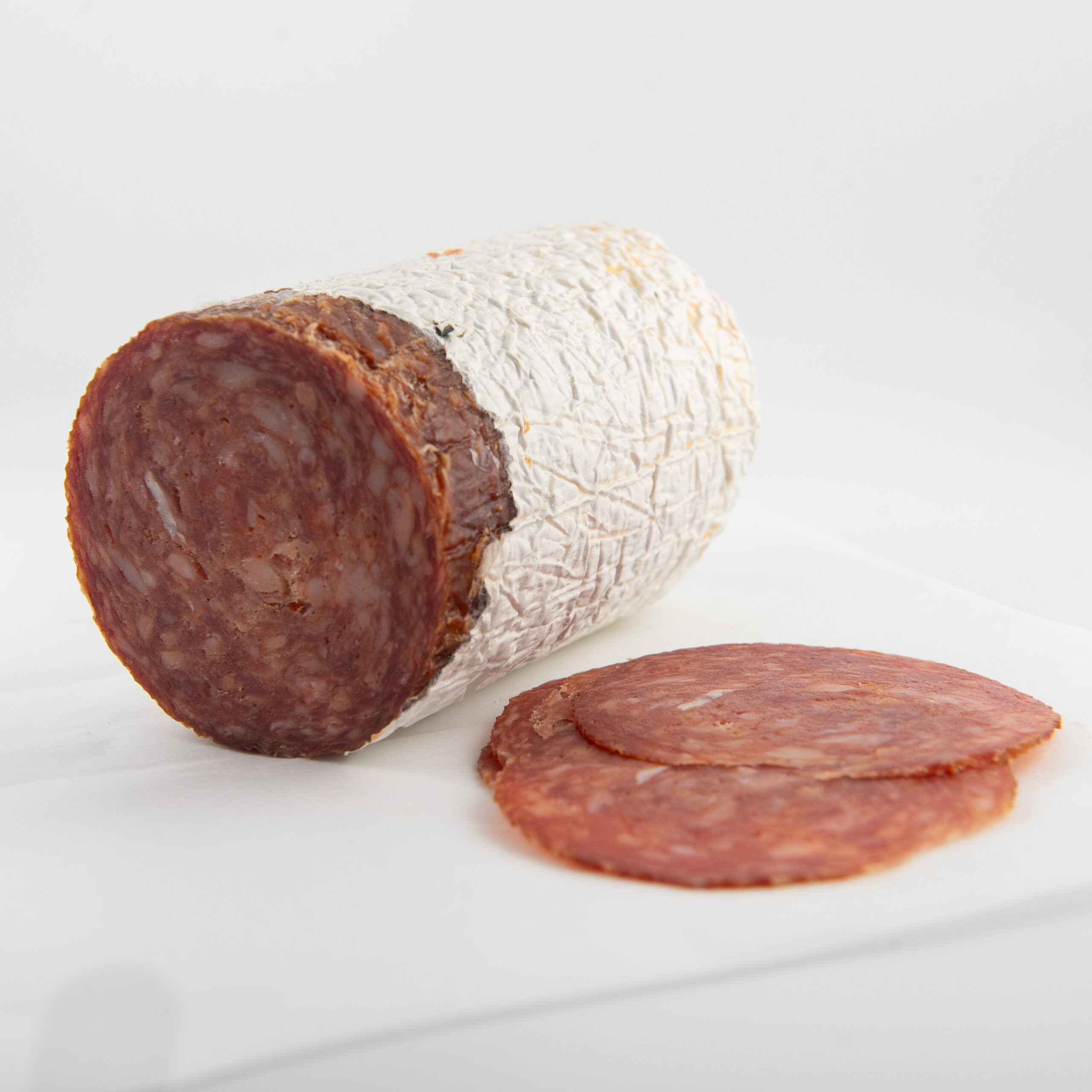 Whole spicy Hungarian salami on cutting board